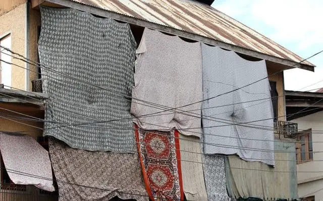 Facade of houses covered with sheets to prevent the stones from hitting the glass windows at Eidgah,Srinagar